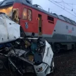 When a freight train and a tourist bus crash, one person is killed and eleven are injured.