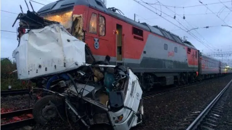 When a freight train and a tourist bus crash, one person is killed and eleven are injured.